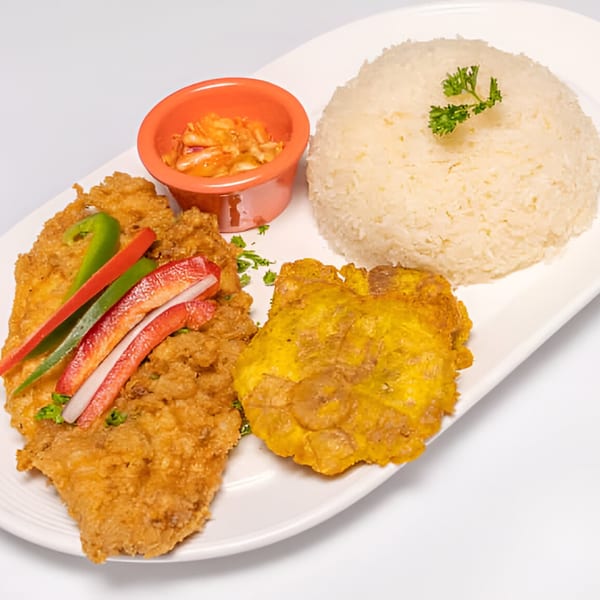Haitian fried fish with bell peppers, rice, fried plantains, and a side of pikliz.